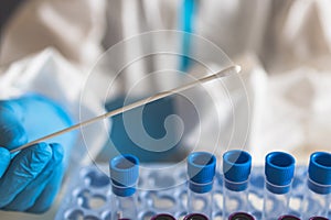 Process of coronavirus PCR antigen testing examination by nurse medic in laboratory lab, COVID-19 swab collection kit, test tube