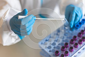 Process of coronavirus PCR antigen testing examination by nurse medic in laboratory lab, COVID-19 swab collection kit, test tube