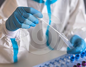 Process of coronavirus PCR antigen testing examination by nurse medic in laboratory lab, COVID-19 swab collection kit, test tube