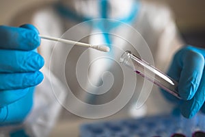 Process of coronavirus PCR antigen testing examination by nurse medic in laboratory lab, COVID-19 swab collection kit, test tube