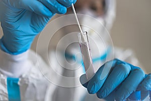 Process of coronavirus PCR antigen testing examination by nurse medic in laboratory lab, COVID-19 swab collection kit, test tube