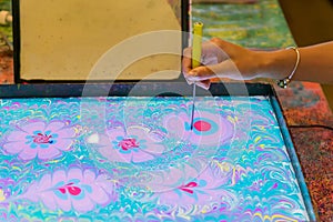 Process of creating drawing in ebru technique. Painting on the water