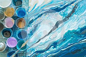 The process of creating a picture in the technique of fluid art liquid acrylic