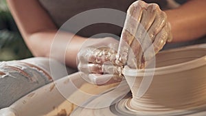 The process of creating pottery on a potter`s wheel. Close up