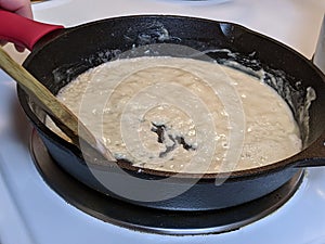 Process of creating a roux out of flour and butter in a cast iron skillet
