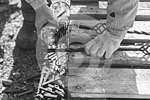 The process of cutting metal using the angle grinder. Grayscale effect.