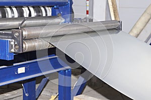 Process of cutting a wide sheet of metal into narrow strips on a machine