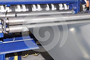 Process of cutting a wide sheet of metal into narrow strips on a machine