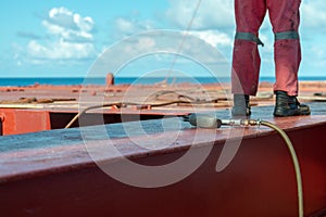 Process of derusting, paint and rust removal by pneumatic chisel from ship deck by vessel crew