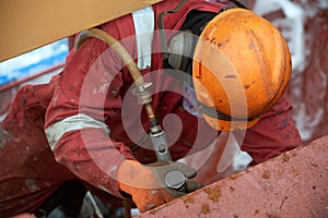 Process of derusting, paint and rust removal by pneumatic chisel from ship deck by vessel crew