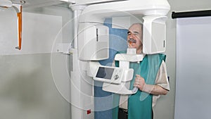 Process of examination of the patient by using panoramic and cephalometric X-Ray scanner photo