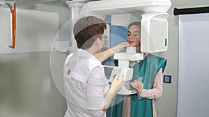 Process of examination teeth of young woman by using panoramic and cephalometric X-Ray scanner photo