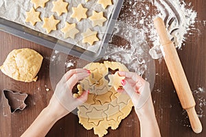 Process of extrusion gingerbread cookies in the shape of a star.