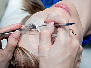 Process of eyelash extension in a beauty salon.