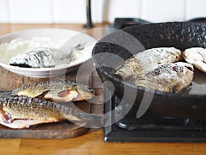 The process of frying river fish crucian carp in a pan on a kitchen stove.River fish of Russian rivers