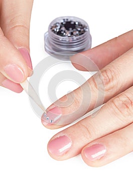 Process of gluing small paste on nail photo