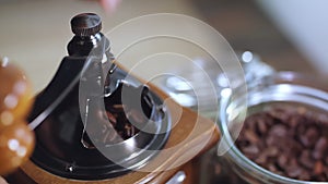 The process of grinding coffee beans in a retro mill.