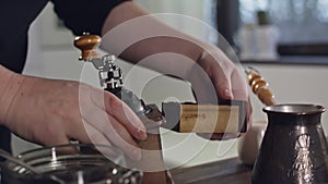 The process of grinding coffee beans in a retro mill.