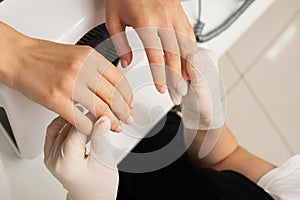 Process of hand massage. clean fair skin, well-groomed manicure, unrecognizable people photo