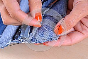 Process of handmade sewing with denim cloth and needle