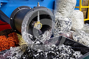 The process of industrial plastic shredding at a waste recycling plant. Converting waste into resources is the process