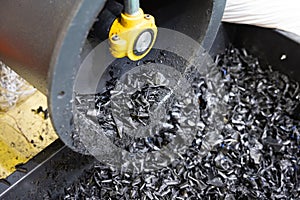 The process of industrial plastic shredding at a waste recycling plant. Converting waste into resources is the process