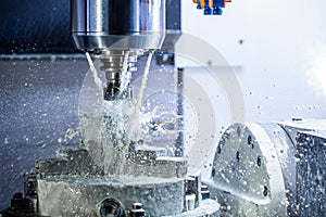 A process of industrial wet milling in 5-axis cnc machine with coolant flow under pressure and freezed splashes