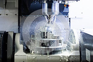 A process of industrial wet milling in 5-axis cnc machine with coolant flow under pressure and freezed splashes