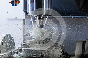 a process of industrial wet milling in 5-axis cnc machine with coolant flow under pressure and freezed splashes