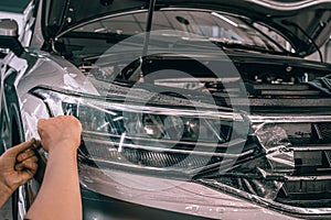 Process of installing PPF or Paint Protection Film or anti-gravel polyurethane film or polymer as protective skin from photo