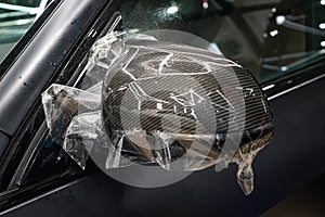 The process of installing PPF on the side mirror. Car wrapping close-up. Car wrapping.
