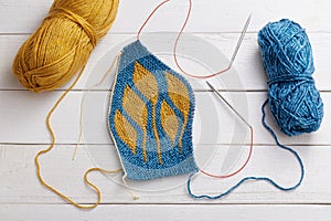 The process of knitting a hat with circular knitting needles using the short rows method