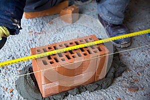The process of laying bricks on construction site