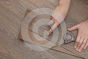 The process of laying vinyl flooring in public places, cutting brown vinyl floors. Resistant floors in common areas