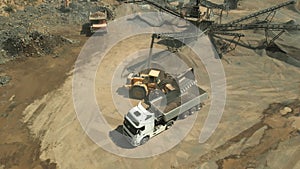 The process of loading coal into a truck.