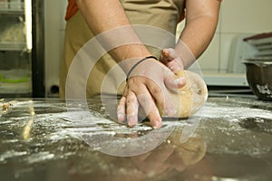 The process of making bread. The chef kneads the dough by hand