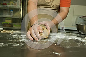 The process of making bread. The chef kneads the dough by hand