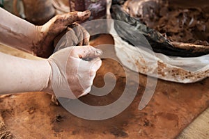 The process of making a ceramic product in close-up. Hands make clay from various items for home and sale