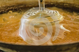 Process of making coconut sugar. Motion Blur.