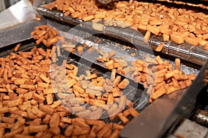 Process of making croutons. Cracker on conveyor. Bread products on conveyor line, in food factory or in factory with