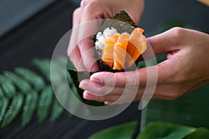 The process of making and decorating salmon Temaki Hand Roll.
