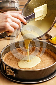 Process of making a delicious lemon cheesecake - pouring dough