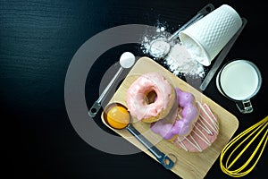 The process of making donuts and ingredient. flour, egg, sugar, milk. top view