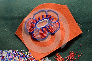 Process of making a flower beaded brooch - master class - embroidery with red and blue beads, woman hobby