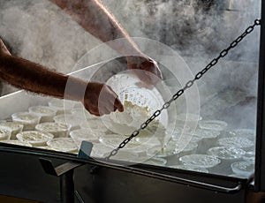 Process of making fresh white soft ricotta whey cheese on small cheese farm in Parma, Italy