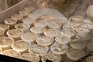 Process of making fresh white soft ricotta whey cheese on small cheese farm in Parma, Italy