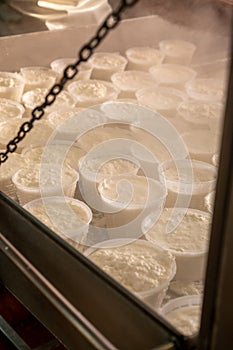 Process of making fresh white soft ricotta whey cheese on small cheese farm in Parma, Italy