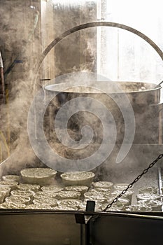 Process of making fresh white soft ricotta whey cheese on small cheese farm in Parma, Italy