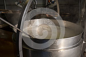 Process of making fresh white soft ricotta whey cheese on small cheese farm in Parma, Italy