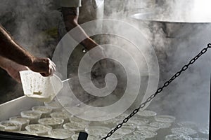 Process of making fresh white soft ricotta whey cheese on small cheese farm in Parma, Italy